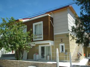 a house with a staircase in front of it at DİDİM Ege Apart in Didim