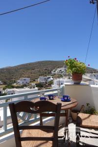 a table and chairs on a balcony with a view at Traditional Apartment In Kastro in Síkinos
