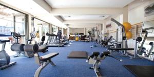 a gym with a bunch of treadmills and machines at One Bedroom Apartment - fully equipped Waterfront based in Cape Town