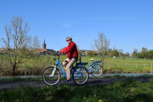 a man riding a bike down a road at Domaine du Port Sainte Marie in Maizi&egrave;res-l&egrave;s-Vic