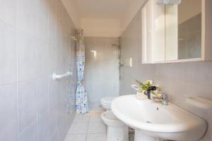 a white bathroom with a sink and a toilet at Villa Salento in Torre Santa Sabina +37 photos