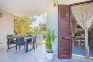 a patio with a table and chairs and a dining room at Villa Salento in Torre Santa Sabina