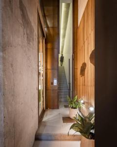 a hallway of a house with a person walking up the stairs at Cbmona Suites in Villa Mercedes