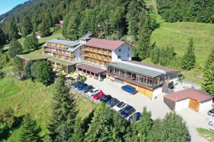 an aerial view of a building with cars parked in a parking lot at Bio-Berghotel Ifenblick in Balderschwang