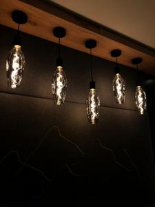a row of lights hanging from a ceiling at Dollinger in Innsbruck