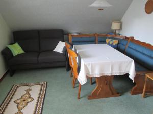 a living room with a table and a couch at Haus Spiegel in Hilders