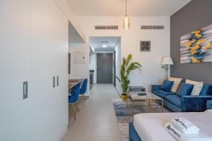 a living room with a bed and a couch at Primestay - Stylish & Brilliant Studio in Al Barsha in Dubai