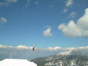 a person on skis on top of a snow covered mountain at Fortuna Apartments in Bansko