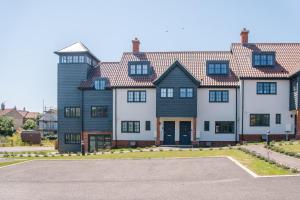 a large house with black and white at 3 Oaks Court, Thorpeness in Thorpeness