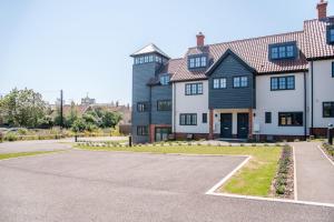 a large house with a driveway in front of it at 3 Oaks Court, Thorpeness in Thorpeness