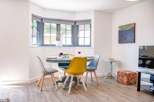 a dining room with a table and chairs at 3 Oaks Court, Thorpeness in Thorpeness