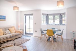 a living room with a couch and a table at 3 Oaks Court, Thorpeness in Thorpeness
