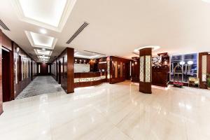 a large room with a lobby with wood paneling at Towlan Qurtaba in Riyadh