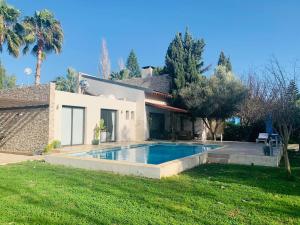 a house with a swimming pool in the yard at The Stone Villa in Pissouri