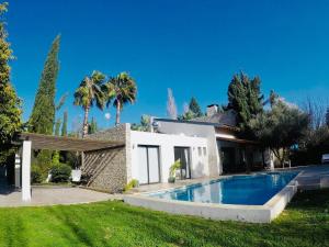 a house with a swimming pool in the yard at The Stone Villa in Pissouri