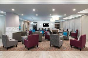 a hotel lobby with chairs and a waiting room at La Quinta by Wyndham Forsyth in Forsyth