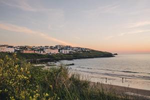 a view of a beach with buildings and the ocean at Fistral Beach Hotel and Spa - Adults Only in Newquay