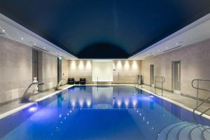 a swimming pool in a hotel with a ceiling at Fistral Beach Hotel and Spa - Adults Only in Newquay
