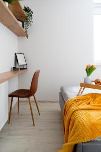 a bedroom with a desk and a chair next to a bed at EASY RENT Apartments - SMART 708 in Lublin