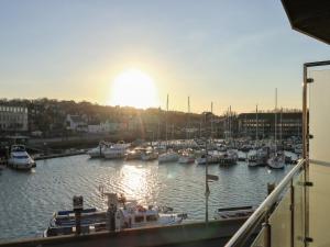 a group of boats in a marina at sunset at Harbourside Haven Apartment 4 in Weymouth