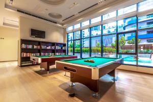 a billiard room with two pool tables and a tv at FAM Living - RP Heights - 3 Mins Walk to Burj Khalifa & Dubai Mall Downtown Dubai in Dubai