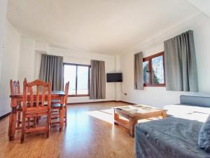 a living room with a table and chairs and a couch at Hotel Boutique La Casa del Río in Villanova