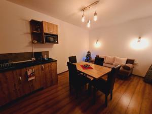 a living room with a table and a couch at Ski Top Busteni in Buşteni