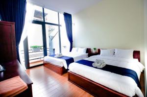 Postel nebo postele na pokoji v ubytování Bách Thảo Hotel
