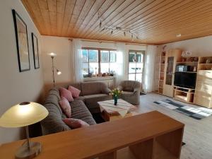 a living room with a couch and a table at Ferienwohnung Michael Vogl in Bodenmais