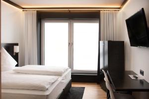 Кровать или кровати в номере BI Hotel by WMM Hotels