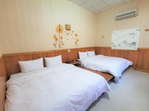 Postel nebo postele na pokoji v ubytování 四重溪可以居民宿 Fine Inn