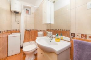 a bathroom with a sink and a toilet at Apartment Kalalarga in Makarska