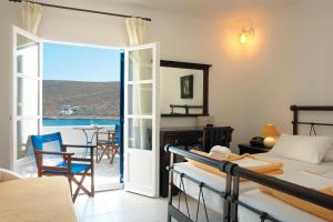 a living room with a view of the ocean at Vardia Bay Studios in Karavostasi