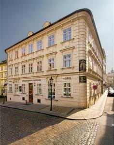 a large building on a street in a city at Three Storks in Prague