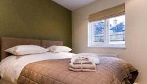a bedroom with a bed with towels on it at The Green House, Harrogate in Harrogate