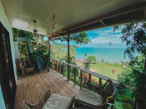 a porch with chairs and a view of the ocean at Pacheco Tours Beach Cabins in Drake