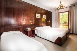 Ένα ή περισσότερα κρεβάτια σε δωμάτιο στο Hotel Capanna d'Oro Dependance +70 φωτογραφίες