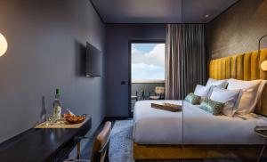 a hotel room with a bed and a table and a dining room at Brown Machne Yehuda in Jerusalem