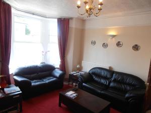 a living room filled with furniture and a fire place at Meadowlea Guest House in Okehampton
