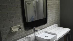 a bathroom with a white sink and a mirror at Gîte, Vintage Touch in Hannonville-sous-les-Côtes +22 photos