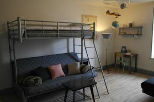 a living room with a bunk bed and a couch at Gîte, Vintage Touch in Hannonville-sous-les-Côtes