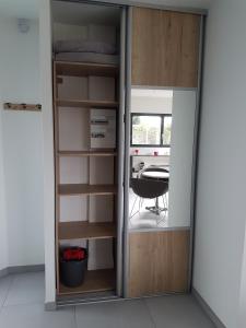 a closet with a glass door with a table in it at Studio Castel Binic in Pordic