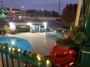 a balcony with two pools and a parking lot at night at Ozark Valley Inn in Branson