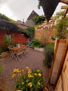 a garden with a table and chairs and flowers at Unique 2 Bedroom Apartment in the Ideal Location in Blackpool