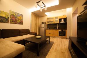 a living room with a couch and a table at Апартамент МИТИ in Pleven