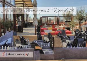 a row of blue chairs sitting in front of a patio at Have a nice stay! - Beach Cottage free parking in Noordwijk aan Zee