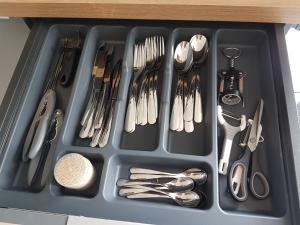 a tray with silver utensils in a drawer at Studio Castel Binic in Pordic