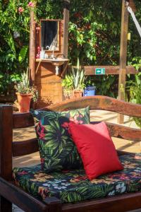 a bench with two pillows sitting on it at Pousada Leão Marinho in Fernando de Noronha