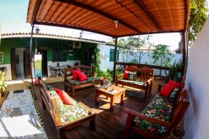 an outdoor patio with couches and a table at Pousada Leão Marinho in Fernando de Noronha