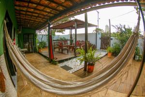a hammock on a house with a patio at Pousada Leão Marinho in Fernando de Noronha